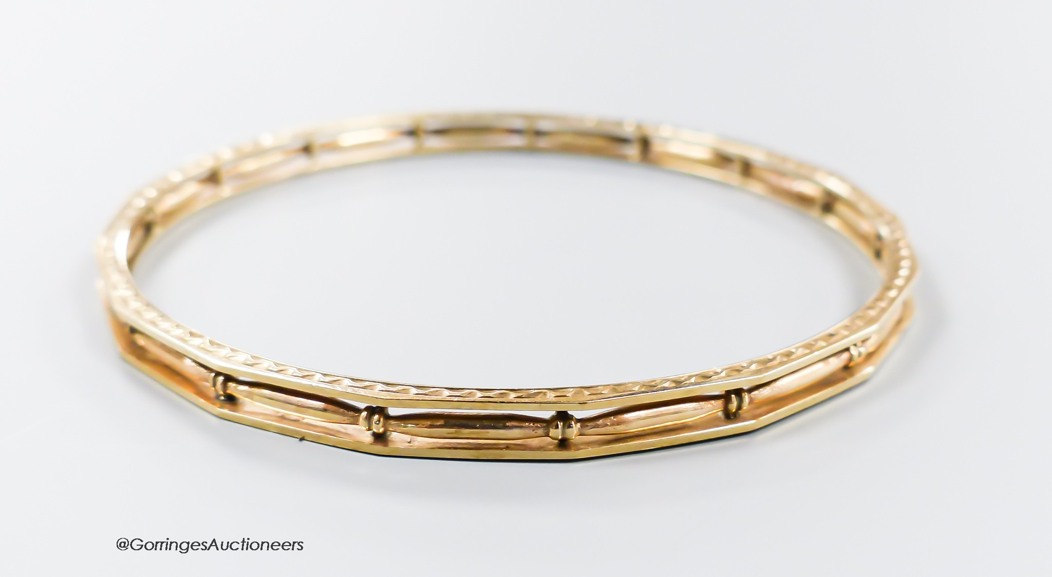 A pierced 9ct bangle, interior diameter 68mm, 13.2 grams.